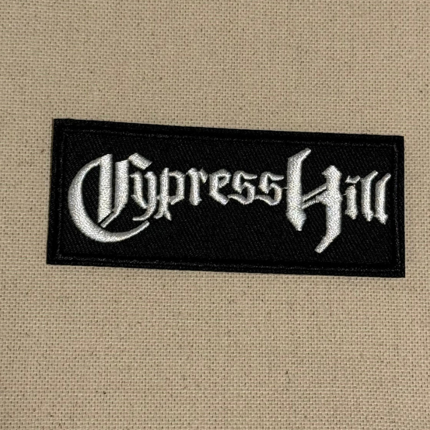 Embroidered patch with 'Cypress Hill' logo on a beige fabric background
