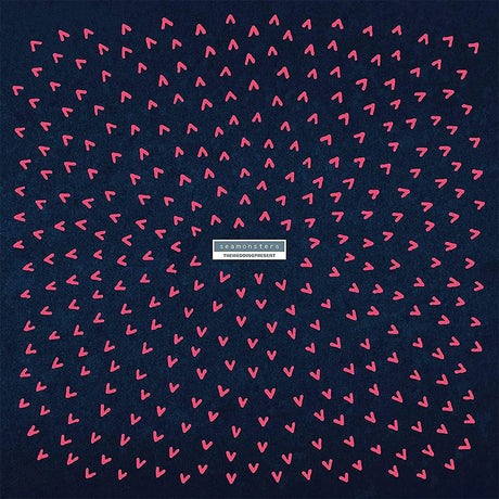 Navy blue background with pink heart pattern and a brand logo in the center.