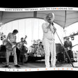 Black and white photo of a band performing on stage with text overlay.