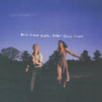 Two blurred figures standing in a field with a blue sky and text 'Never Before Seen, Never Again Found'.