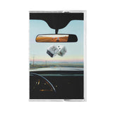 Cassette tape with a car interior and road scene on the cover