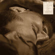 Album cover for Sam Smith's 'Never Let Go', featuring a sepia-toned close-up photograph of a sleeping man's face with a white text box in the top right corner displaying the artist's name and track listing details.