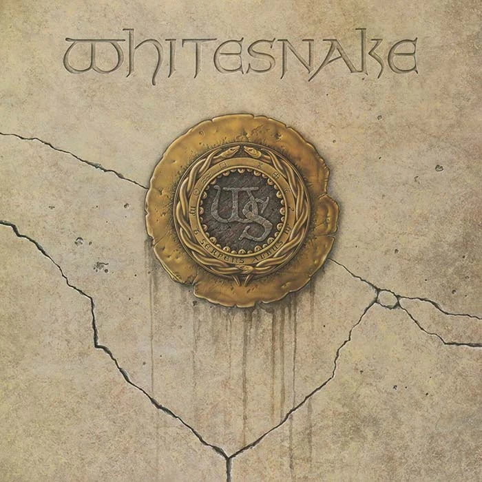Album cover art for Whitesnake, featuring the band name in stylized lettering at the top and an ornate gold seal emblem in the center on a cracked beige stone-like background.