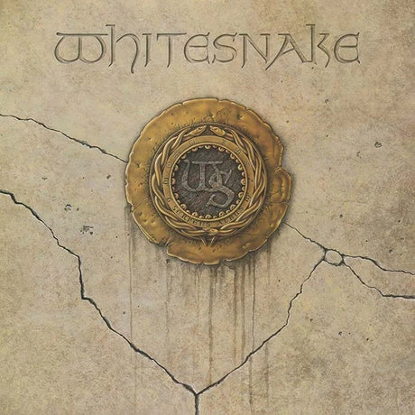 Album cover art for Whitesnake, featuring the band name in stylized lettering at the top and an ornate gold seal emblem in the center on a cracked beige stone-like background.