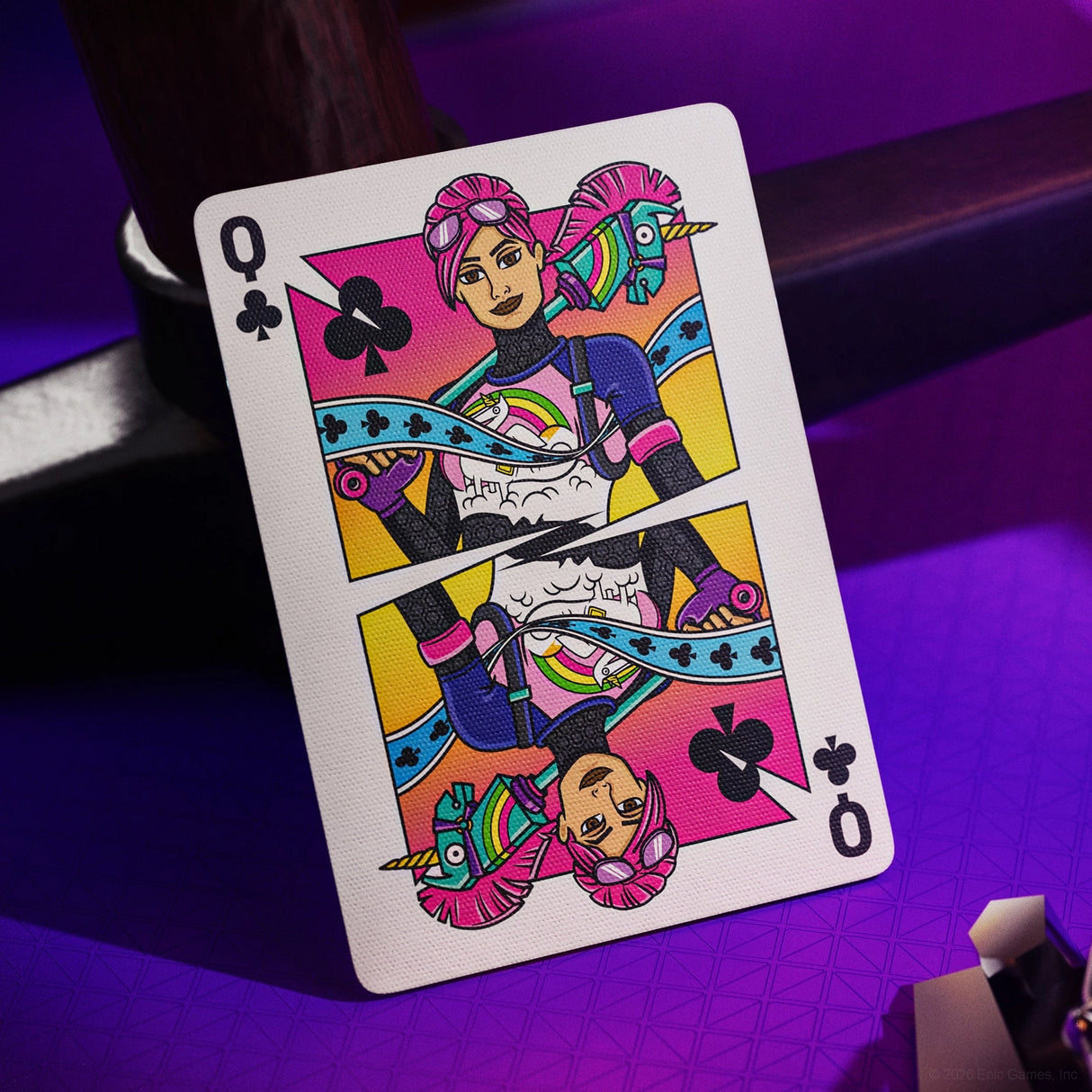 Colorful playing card with a stylized character on a purple surface