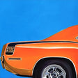 Orange car with 'EARTH' logo on a blue background