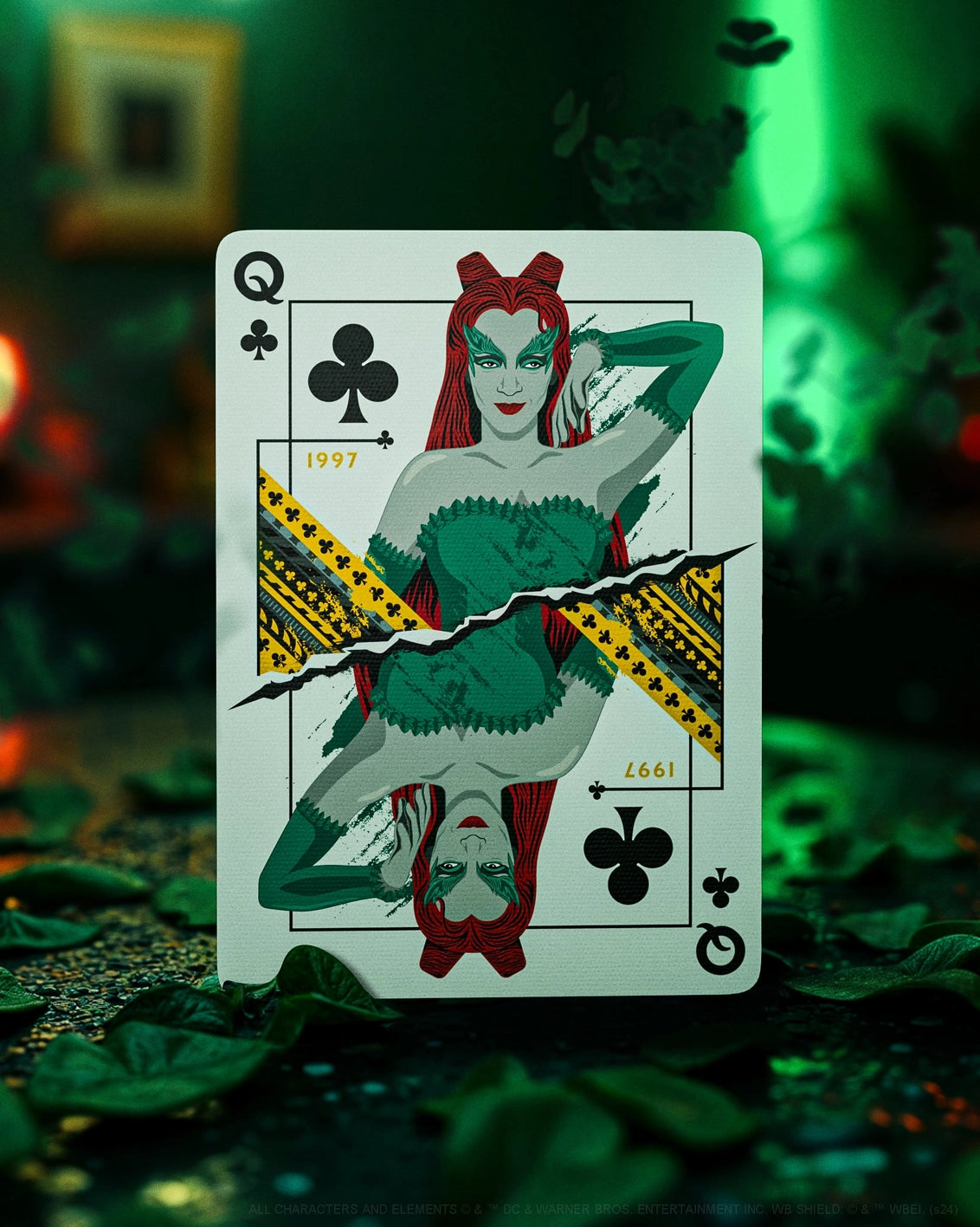 Playing card with a stylized queen design on a dark, leafy background
