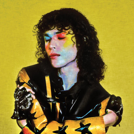 Person wearing a black and yellow outfit with star patterns on a yellow background