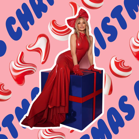 Woman in a red dress sitting on a blue gift box with Christmas-themed background