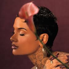 Illustration of a woman with tattoos and a flower in her hair against a dark background