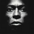 Black and white portrait of a person with a dark background