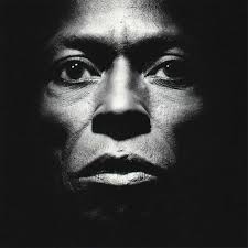 Black and white portrait of a person with a dark background