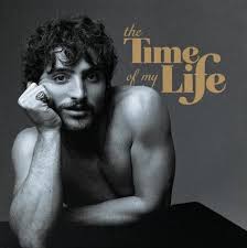 Album cover for 'the Time of my Life' featuring a black and white portrait of a shirtless man resting his head on his hand, with the title in gold text on a dark gray background.