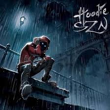 Person wearing a hoodie sitting on a ledge in a rain-soaked urban setting with 'Hoodie SZN' text.