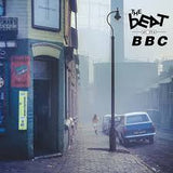 Street scene with a blue car and people walking, featuring 'The Beat' BBC logo.