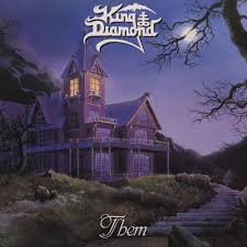 Album cover of King Diamond's 'Them' with a haunted house and moonlit sky.