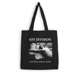Black tote bag with 'Joy Division' design and text on a white background
