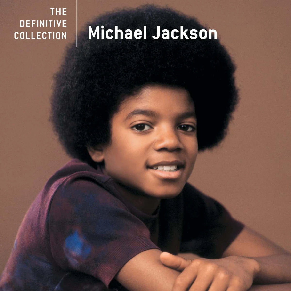 Young Michael Jackson with text 'The Definitive Collection' on a brown background