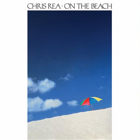 Album cover with a colorful umbrella on a beach under a blue sky.