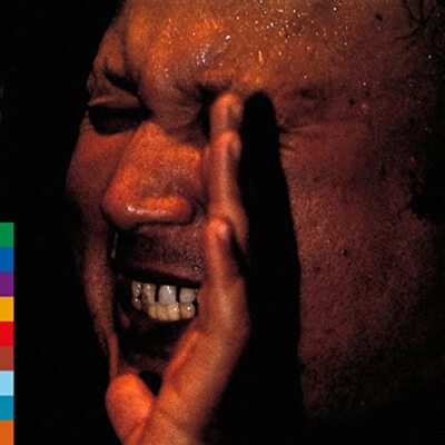 Album cover with a stylized face and hand, featuring a rainbow color bar on the left.