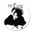 Circular sticker with a black and white illustration of a person and 'The Cure' text on a white background