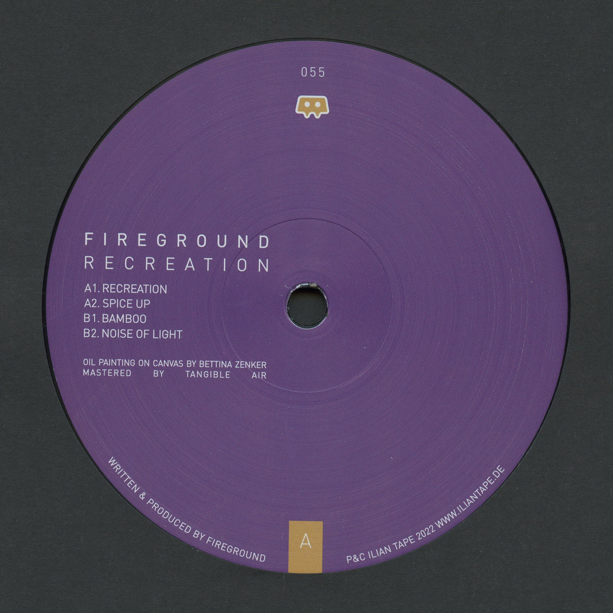 A purple vinyl record label for the music release 'Fireground Recreation' by the artist Fireground, featuring tracklist text and a small gold logo on a dark gray background.