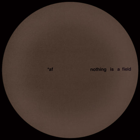 Brown circular object with text 'nothing is a field' on a black background