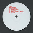 Vinyl record label with red text on a white disc against a black background