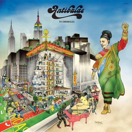 The image features the cover of the Antibalas album 'Fu Chronicles'. It depicts a vibrant and colorful illustration of a cityscape with a parade in progress.
