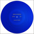 A blue vinyl record of Kanye West's album 'Jesus Is King' with a label that displays the title and artist name.