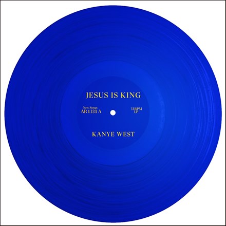 A blue vinyl record of Kanye West's album 'Jesus Is King' with a label that displays the title and artist name.