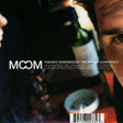 This image features the album cover for "The Mirror Conspiracy" by Thievery Corporation. The cover art is enigmatic and abstract, displaying a blurred, close-up photograph of a person's face with a wine glass and bottle in the background, hinting at the album's eclectic and possibly club-oriented vibe.