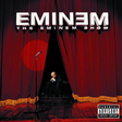 This image features the album cover for "The Eminem Show 2LP," showcasing a powerful and evocative design. The cover art displays a intense and solitary figure, Eminem, standing on a stage with a microphone, silhouetted against a vibrant red backdrop that resembles a setting sun through a curtain.