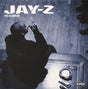 Album cover of Jay-Z - The Blueprint featuring Jay-Z in a black and white photo with a cigarette, sitting at a table with a ashtray and glass.